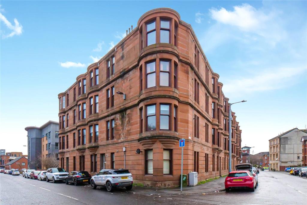 A red sandstone Glasgow tenement corner block from a Ronald Ross sales listing